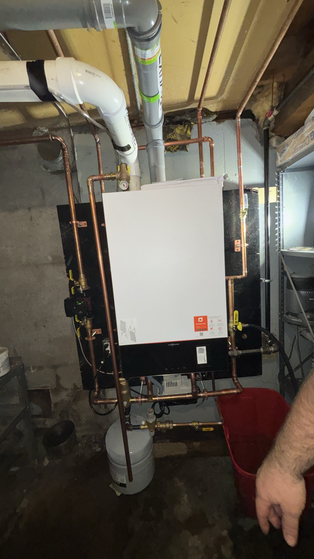 Wall-mounted Viessmann Vitodens 100 combi boiler with copper piping, circulator and expansion tank on a Cape Cod installation