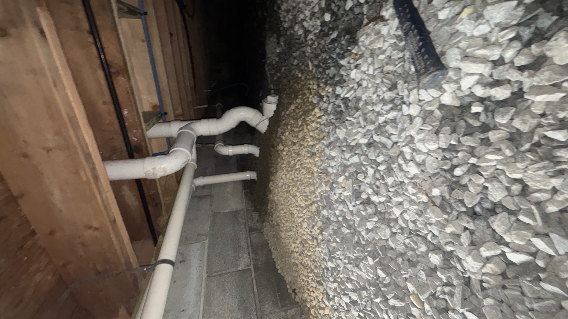 White PVC drain piping and water lines beneath exposed floor framing on a Durfee plumbing project in West Yarmouth, MA